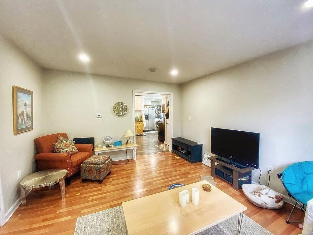 28 Francis Street, Unit 2 Waltham, MA 02451 - Photo 7 of 11 a living room with furniture and a flat screen tv