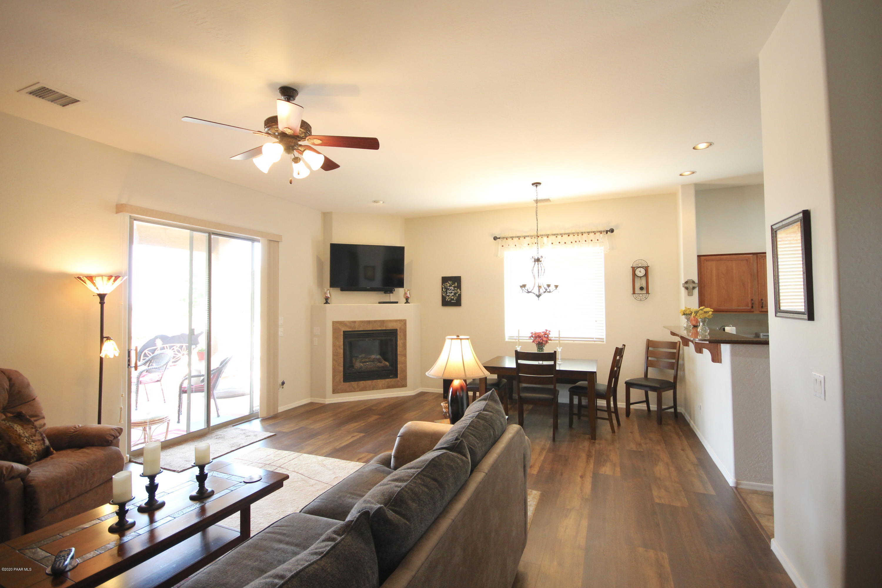 4870 Edgemont Road Prescott Valley, AZ 86314 - Photo 13 of 27 a living room with furniture fireplace and a flat screen tv
