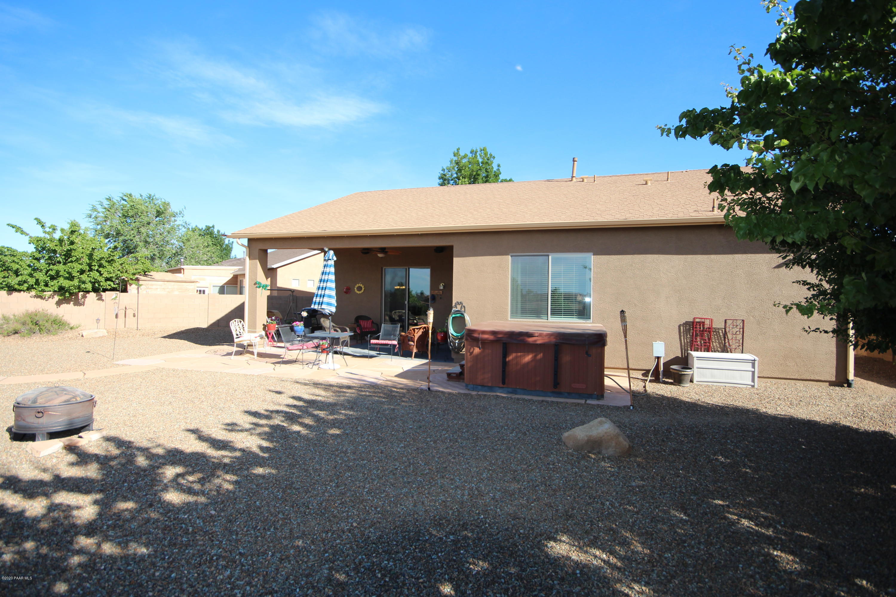 4870 Edgemont Road Prescott Valley, AZ 86314 - Photo 3 of 27 a view of a backyard with table and chairs under an umbrella