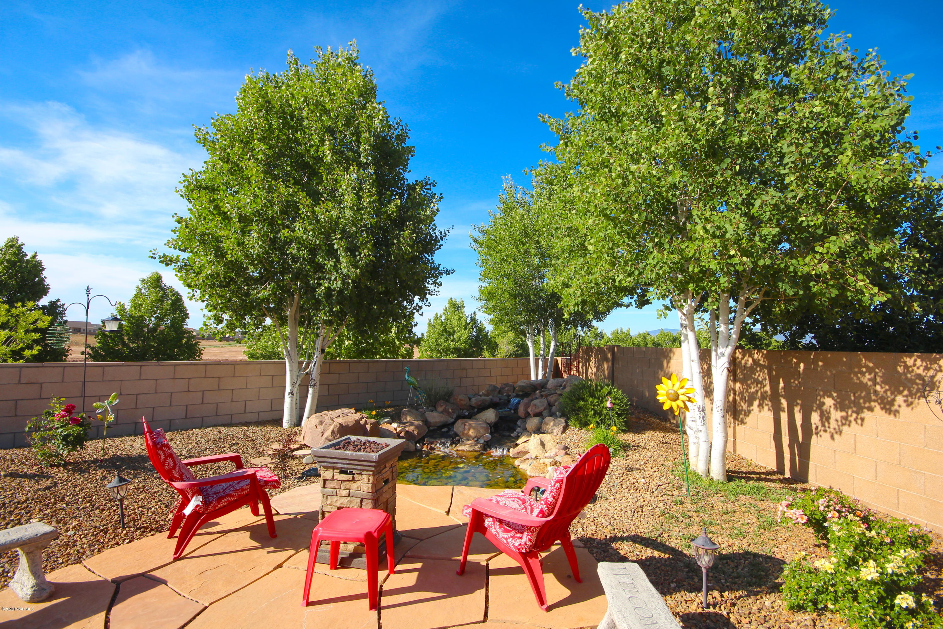 4870 Edgemont Road Prescott Valley, AZ 86314 - Photo 8 of 27 a backyard of a house with table and chairs