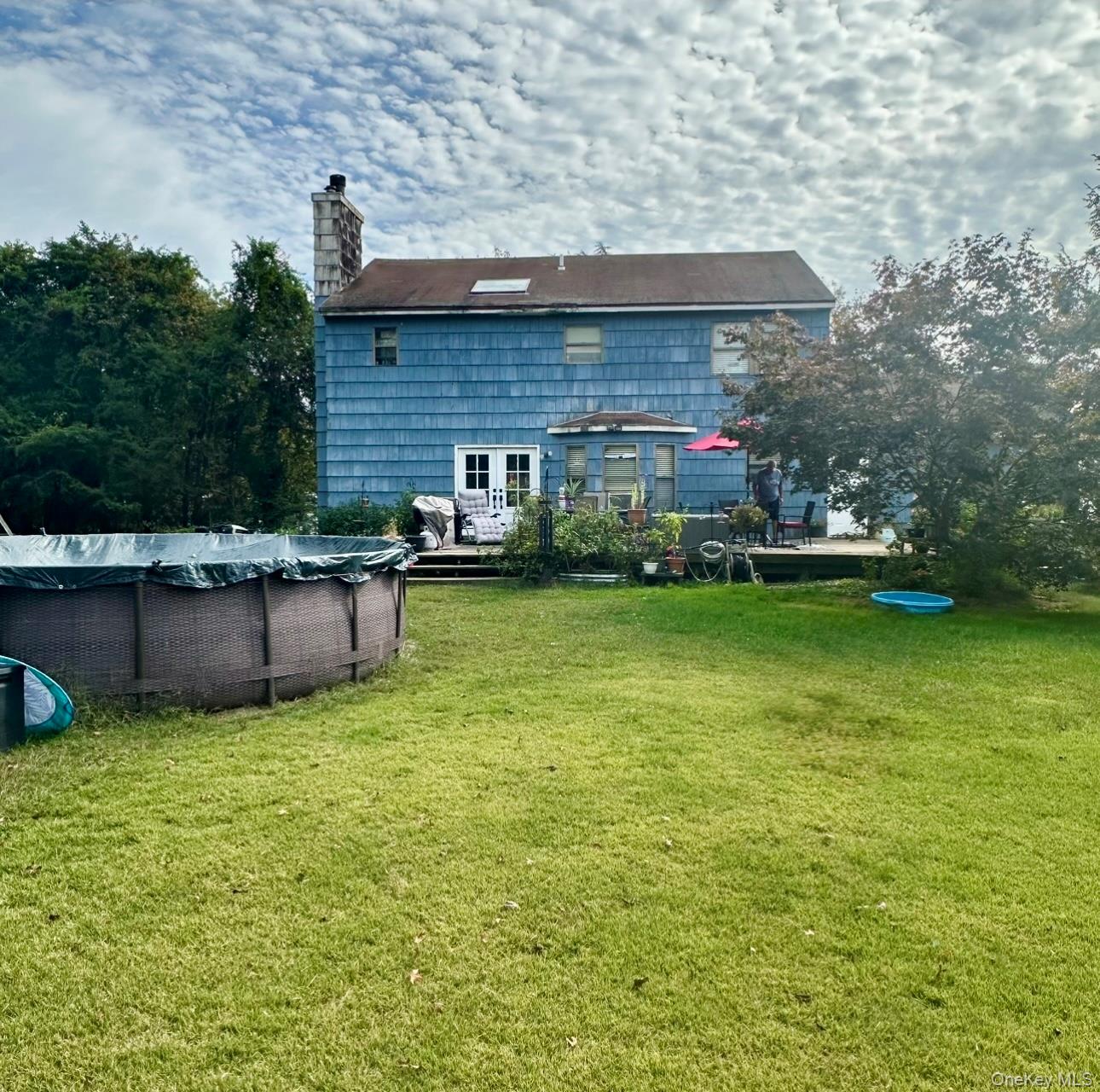 189 Southfield Road Calverton, NY 11933 - Photo 4 of 12 a view of a house with a yard and sitting area