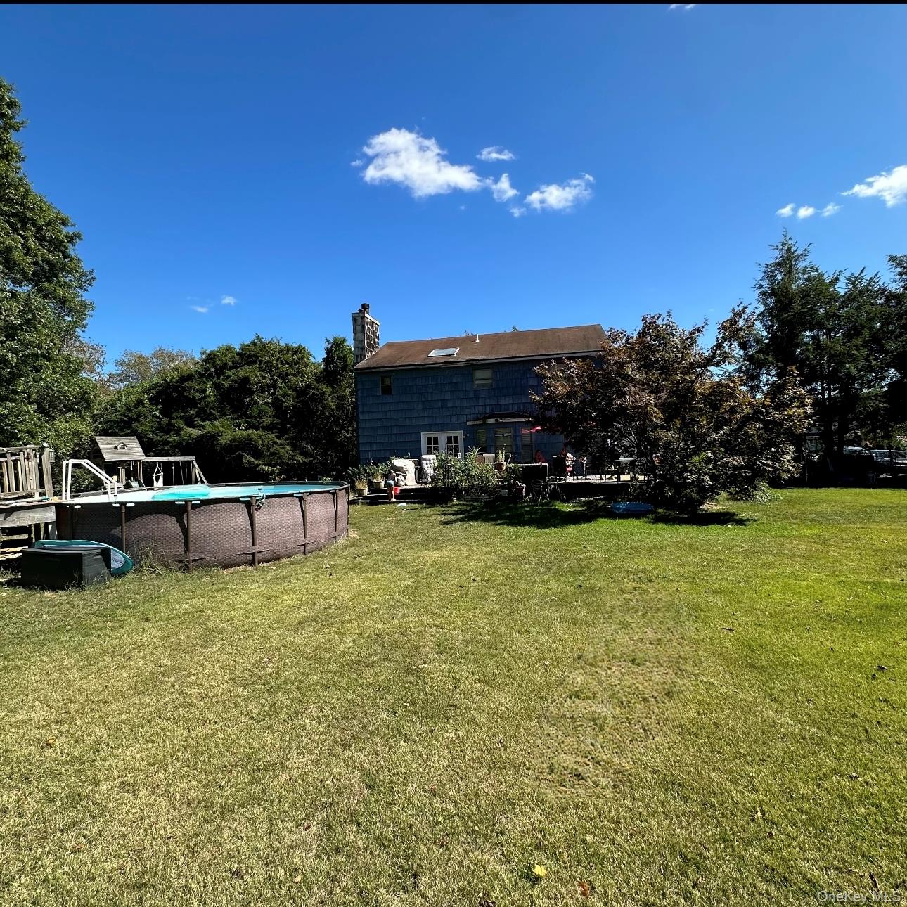 189 Southfield Road Calverton, NY 11933 - Photo 5 of 12 a view of a house with swimming pool and yard