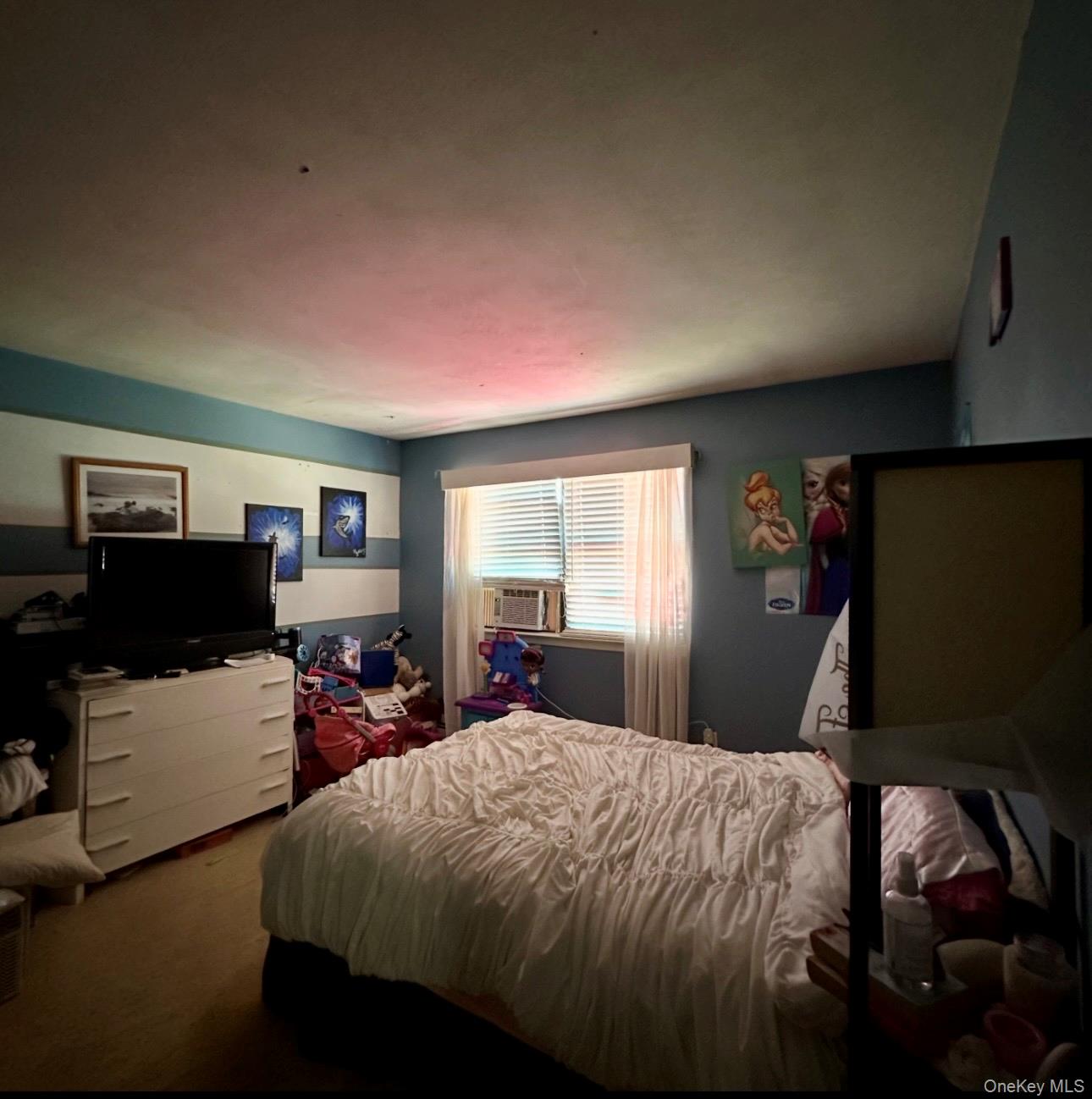 189 Southfield Road Calverton, NY 11933 - Photo 7 of 12 a bed sitting in a bedroom next to a window with tv and couch