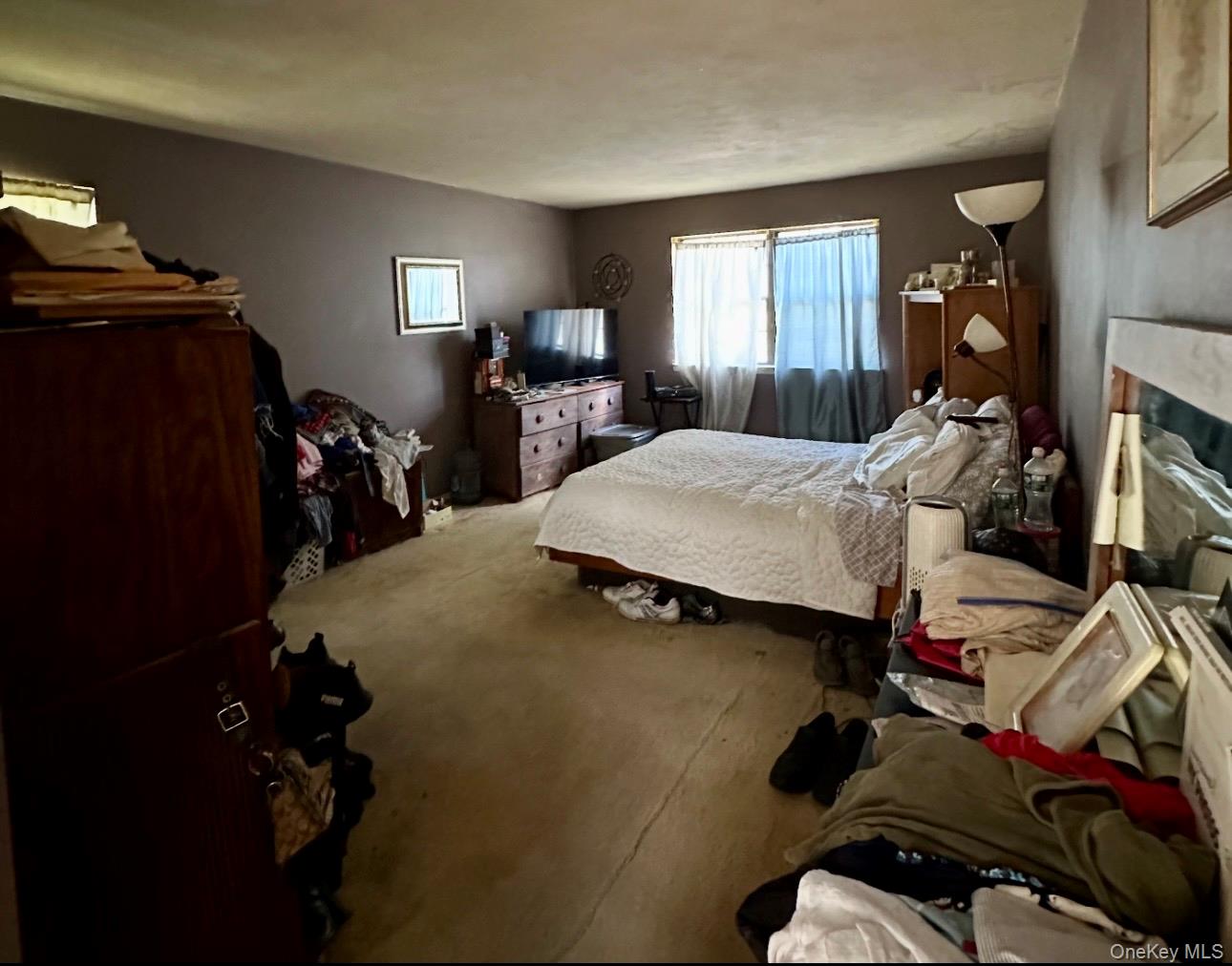 189 Southfield Road Calverton, NY 11933 - Photo 9 of 12 a bed room with a bed and a mirror