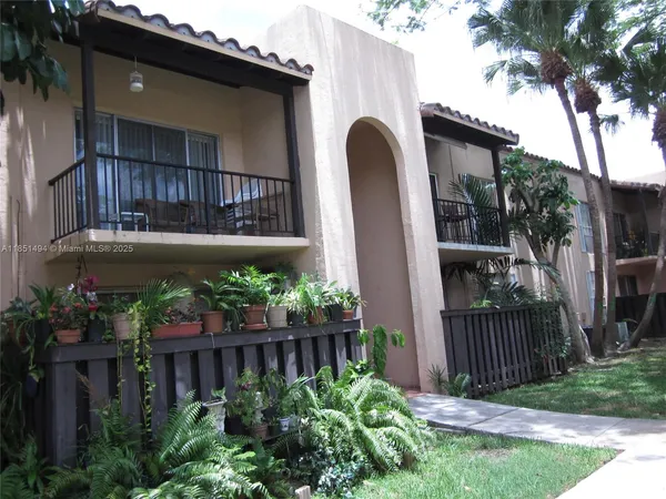 a view of front door and potted plants