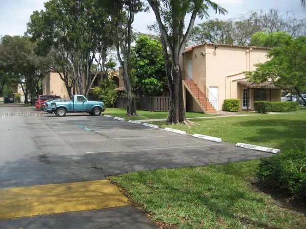 a view of a house with a yard and tree s