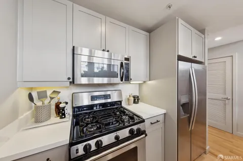 a kitchen with stainless steel appliances a refrigerator a stove and a sink