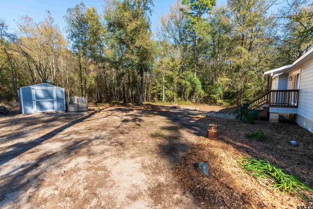 a backyard of a house with lots of green space