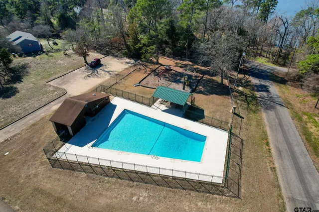 an aerial view of a house with a yard basket ball court