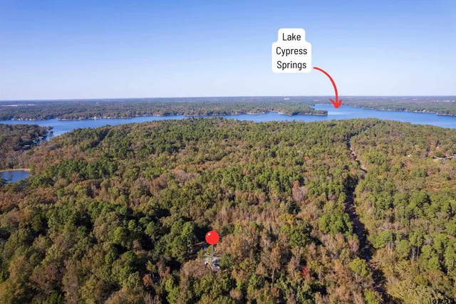 a view of a large building with a field in the background