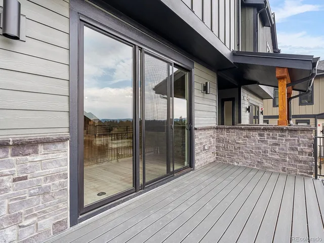 a view of balcony with wooden floor and fence