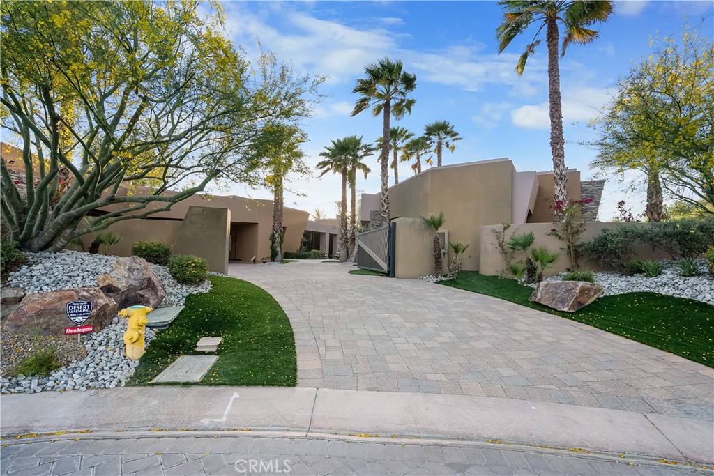 68 Royal St Georges Way Rancho Mirage, CA 92270 - Photo 22 of 75 front view of a house with a yard and potted plants