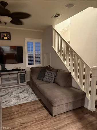 a living room with furniture and flat screen tv