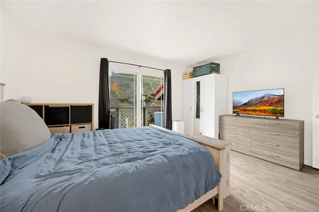 a bedroom with a bed and a large window