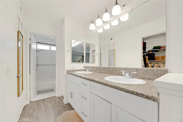 a bathroom with a sink vanity granite and a mirror
