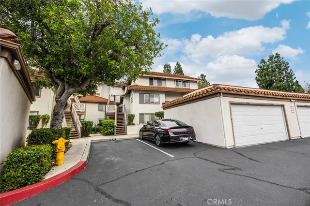 a car parked in front of a white house