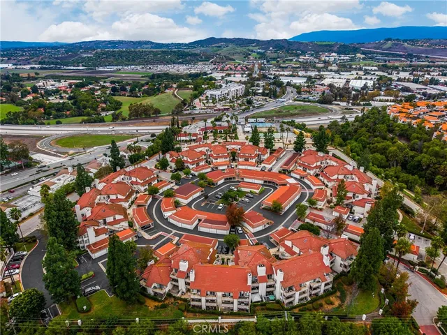 an aerial view of residential houses with outdoor space and river