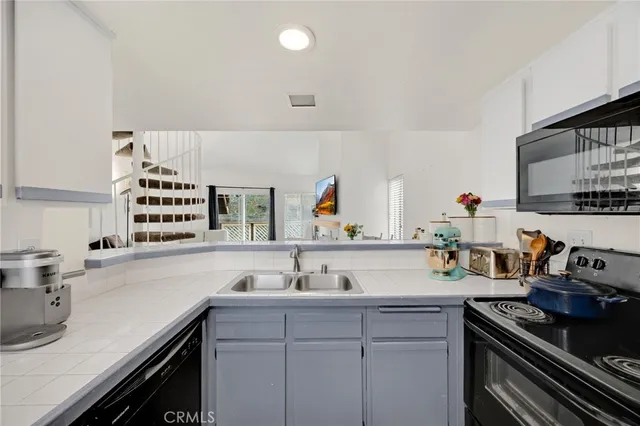 a kitchen with a sink stove and cabinets