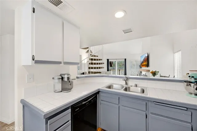 a kitchen with a sink and cabinets