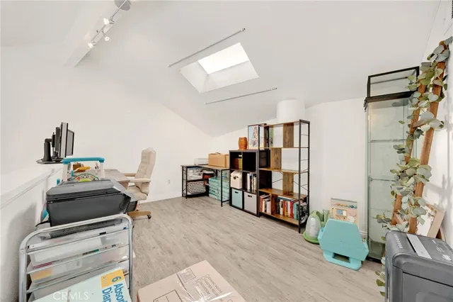 a view of a workspace with furniture and a book shelf