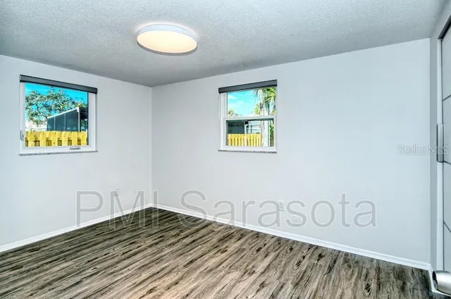 a view of a room with wooden floor and window