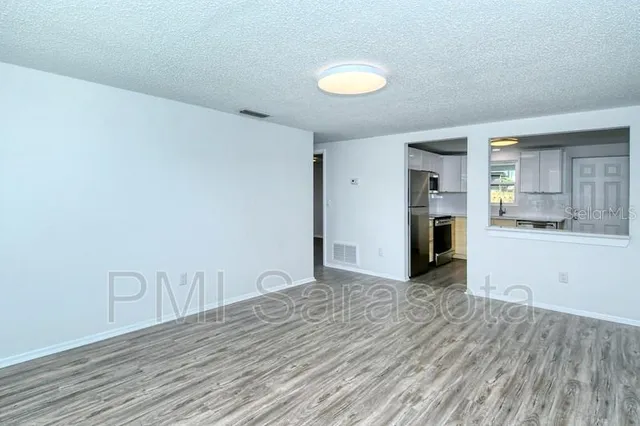 a view of a kitchen with wooden floor and a sink