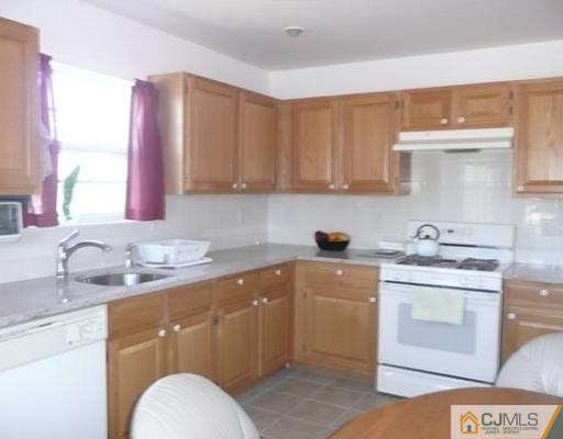 312 Hawthorne Road North Brunswick, NJ 08902 - Photo 5 of 10 a kitchen with a sink stove and cabinets