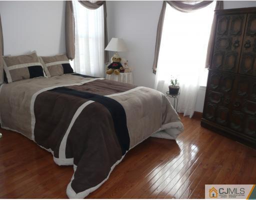 312 Hawthorne Road North Brunswick, NJ 08902 - Photo 7 of 10 a bedroom with a bed and a night stand