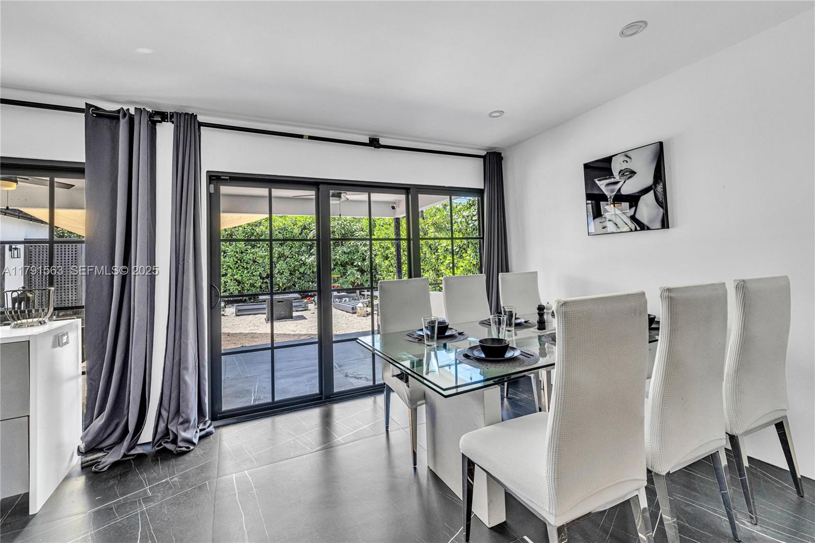 560 Northwest 116th Terrace Miami, FL 33168 - Photo 13 of 50 a living room with furniture and a floor to ceiling window