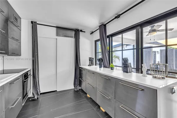 a large white kitchen with a large window
