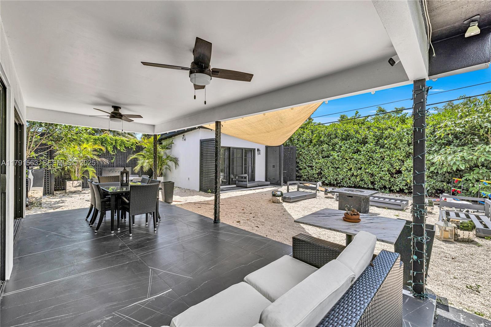 560 Northwest 116th Terrace Miami, FL 33168 - Photo 24 of 50 a living room with patio furniture and a large window