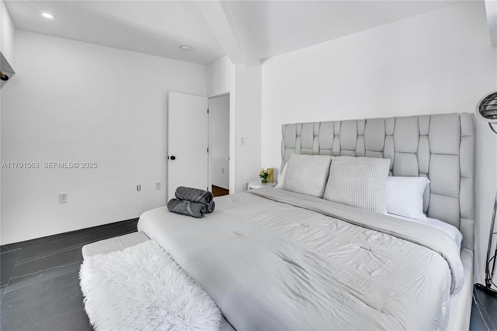 560 Northwest 116th Terrace Miami, FL 33168 - Photo 25 of 50 a bedroom with a bed and wooden floor