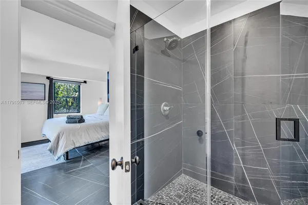 a bathroom with a bathtub and a shower