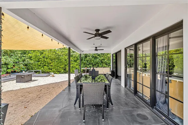 a dining room with furniture window and outside view