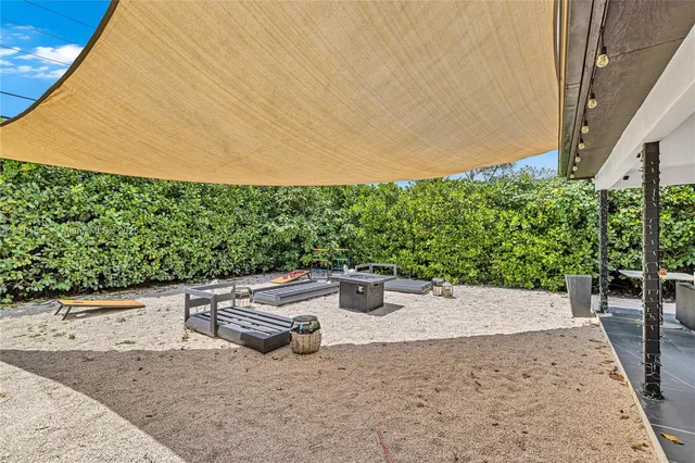 a wooden bench sitting in the middle of a backyard