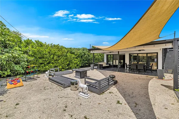 a view of a house with swimming pool and sitting area