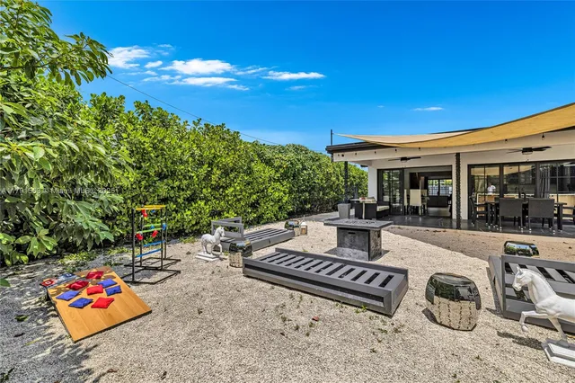 a view of a patio with couches and table and chairs and potted plants