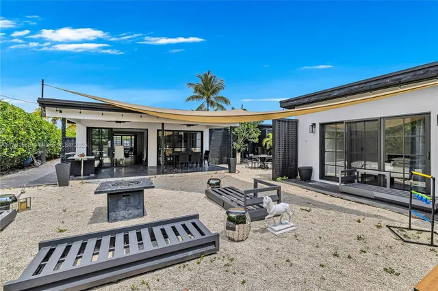 a view of a house with backyard sitting area and porch