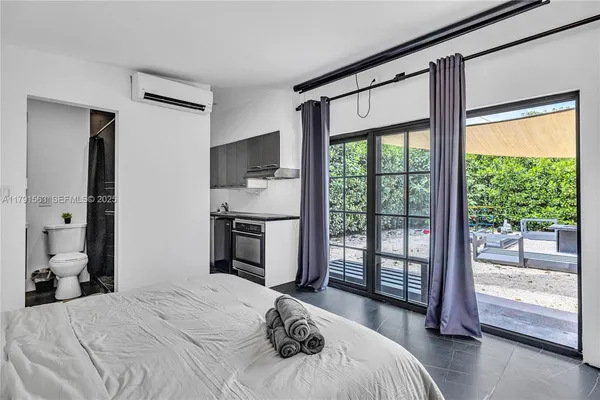 a bedroom with a large bed and a large window