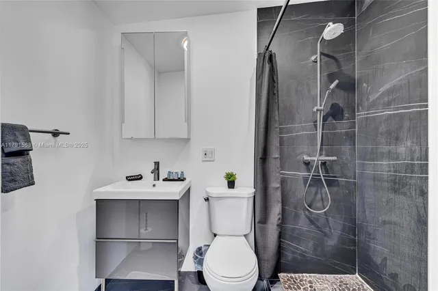 a bathroom with a sink toilet and shower