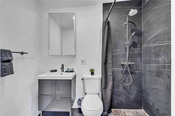 a bathroom with a sink toilet and shower
