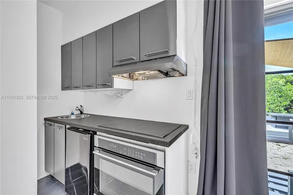 a view of a kitchen with sink and cabinets