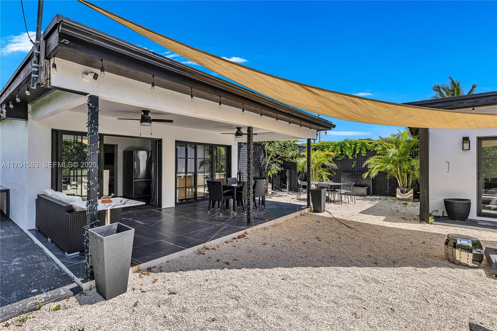 560 Northwest 116th Terrace Miami, FL 33168 - Photo 43 of 50 a building outdoor space with patio furniture and potted plants