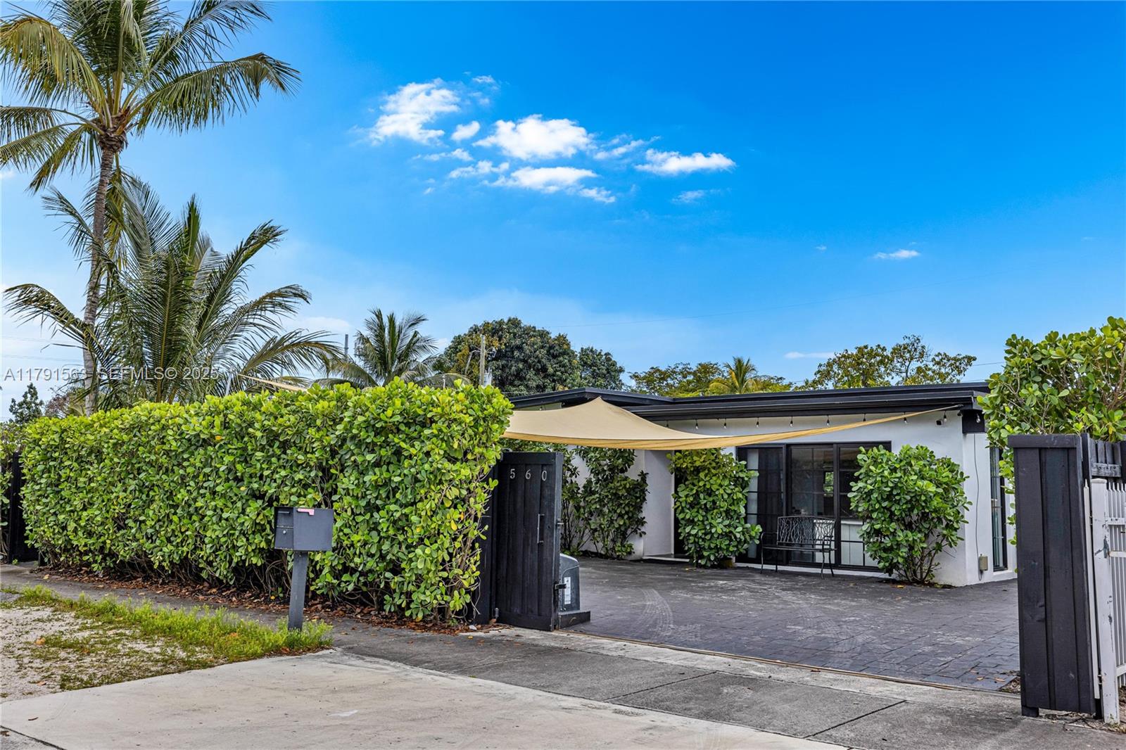 560 Northwest 116th Terrace Miami, FL 33168 - Photo 45 of 50 a view of a house with a yard and potted plants