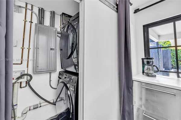 a view of a hallway with furniture and front door