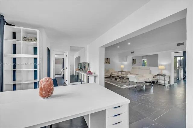 a living room with furniture a table and chairs