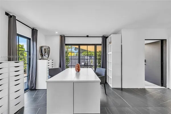 a room with a bed and a large window