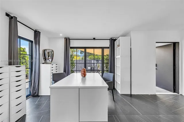 a room with a bed and a large window