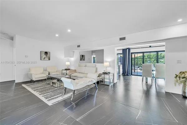a living room with furniture rug and view of bedroom
