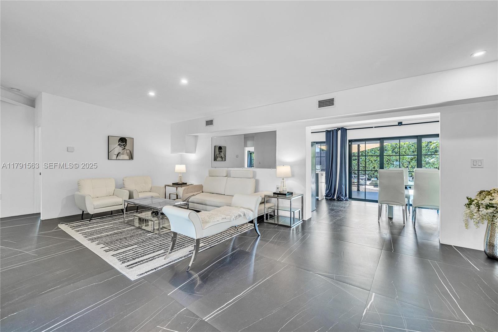 560 Northwest 116th Terrace Miami, FL 33168 - Photo 7 of 50 a living room with furniture rug and view of bedroom